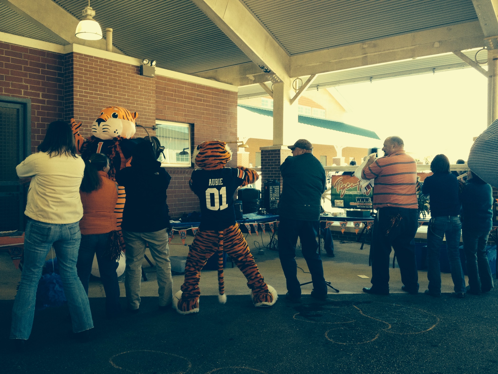 Several people dancing with Aubie