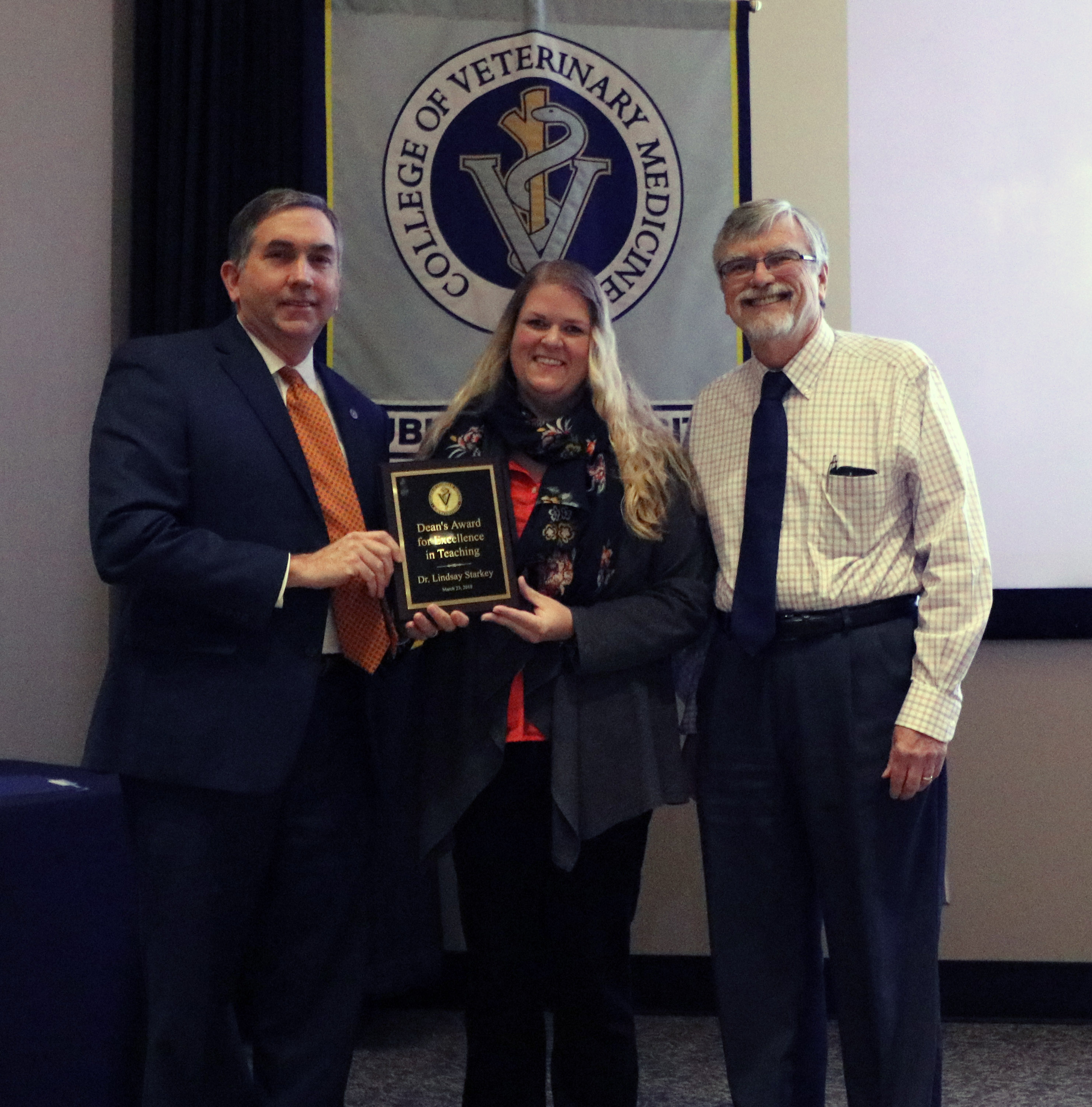 Dean Johnson, Dr. Starkey and Dr. Russ Cattley, who presented the award.