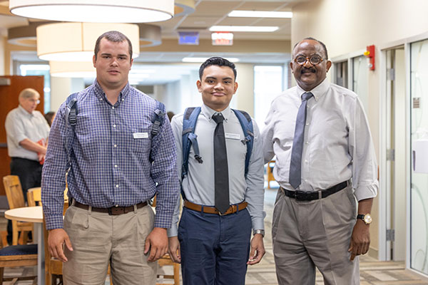 Dr. Mansour with two students