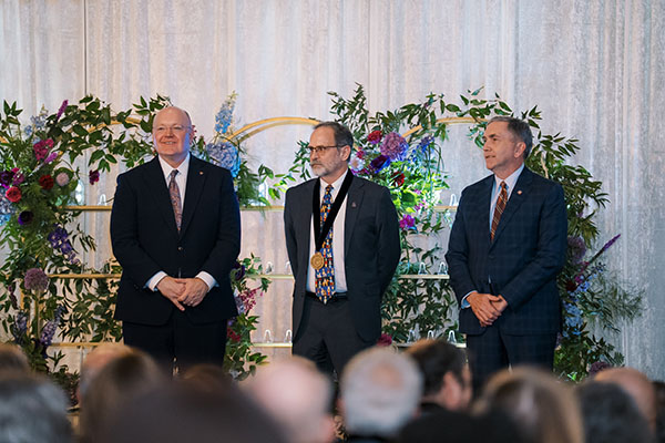 Dr. Michael Tillson (center) is celebrated on stage during the 2025 Auburn University Endowed Faculty Recognition Ceremony. Pictured with him (left to right) are Auburn University President Christopher Roberts and College of Veterinary Medicine Dean Calvin Johnson.