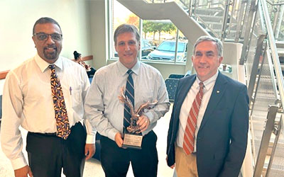 Dr. Sanjeev Narayanan with Dr. Paul Walz and Dean Calvin Johnson.