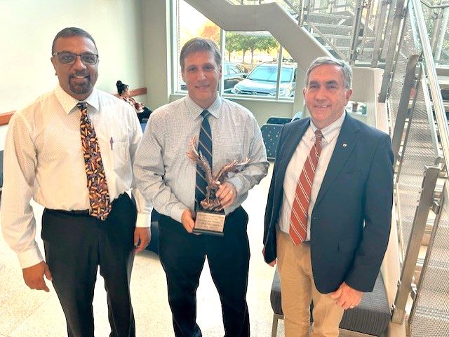 Dr. Sanjeev Narayanan with Dr. Paul Walz and Dean Calvin Johnson.