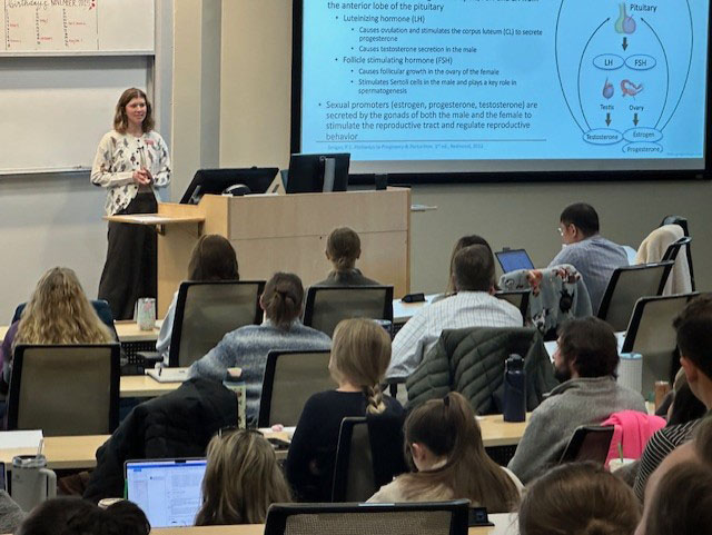 Student presenting in lecture hall